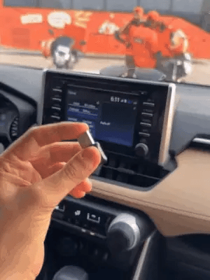 Wireless Car Play adapter by My Store connected to a car's dashboard display, enabling seamless smartphone integration.shop_this_look_amDhCa